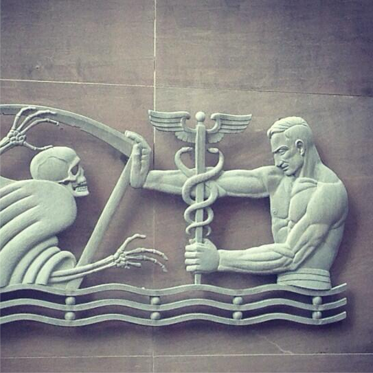 Stone relief of Asclepius, the ancient symbol of medicine